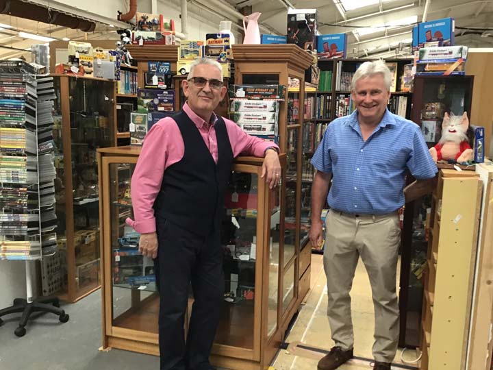 Grant and Adrian with Collectables in Glass Cabinets